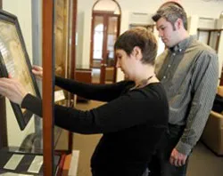 Archivist Leslie Knoblauch and Paul Wesley Bush place the etching on display. ?w=200&h=150