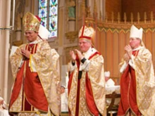 Archbishop Thomas Collins (center) presides over the ordination of  Bishops Bill McGratten and Vincent Nguyen. 