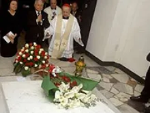 Card. Dziwisz kneels in prayer with Polish President Lech Kaczynski, at the tomb of Pope John Paul II