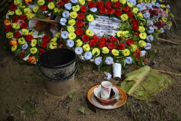 Bangladesh crash - Flowers and offerings are placed at the grave of Ukya Chhaing Marma. The seventh-grader died from his wounds after being rescued from the July 21 plane crash at his Dhaka school.