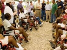 Supreme Knight Carl Anderson greets Haitian earthquake victims who received wheelchairs on April 27. 