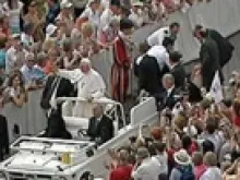 Young German man trying to board the Popemobile