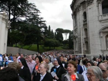 The faithful pray the Rosary in procession to the grotto of Our Lady of Lourdes.