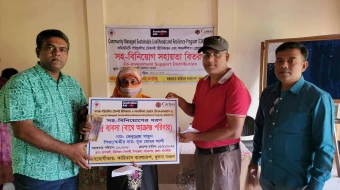 Tiger widow Zebunnesa Khatun, wife of late Mohor Ali, receives help from Caritas Khulna Region on Nov. 15, 2025.