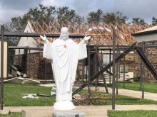 Statue of Jesus in front of damaged church property, Diocese of Lake Chares. 