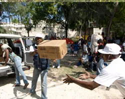 CRS workers unload aid packages in Port-au-Prince. ?w=200&h=150