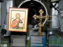 One of the icons and a cross floating in zero gravity on the ISS.  