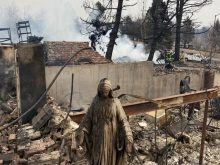 A Mary statue stands amid the remains of the Greany home in Louisville, Colo., following the Marshall Fire.