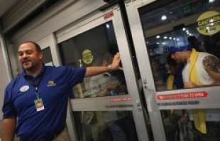 Shoppers wait to enter a Best Buy store on Nov. 25, 2011 in Naples, Fla. Although controversial, many big retail stores decided to open on Thanksgiving Day or at midnight. Spencer Platt/Getty Images