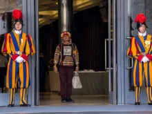 A participant in the Vatican's Amazon synod is flanked by two members of the Swiss Guard. 