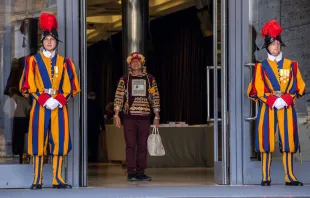 A participant in the Vatican's Amazon synod is flanked by two members of the Swiss Guard.   Daniel Ibanez/CNA
