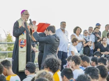 Patriarch Pierbattista Pizzaballa praying with young Catholics on the Mount of Beatitudes on July 19, 2022