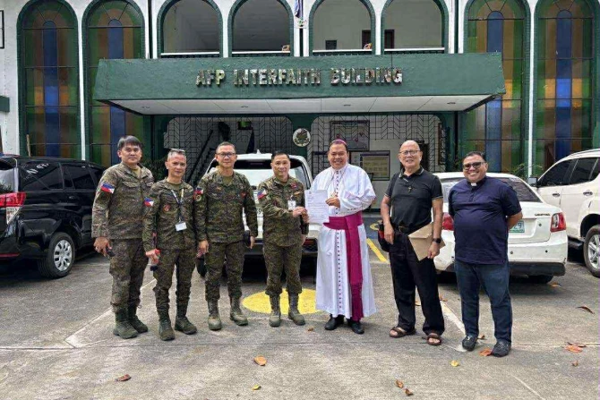 Bishop Elias Ayuban Jr. of Cubao hands over a letter of support to Armed Forces of the Philippines (AFP) Chief of Staff Romeo Brawner Jr. at Camp Aguinaldo, Manila on Nov. 14, 2025.