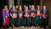 Graduates pose with their degrees at St. Mary’s University College in Belfast, Northern Ireland.
