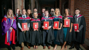 Graduates pose with their degrees at St. Mary’s University College in Belfast, Northern Ireland.