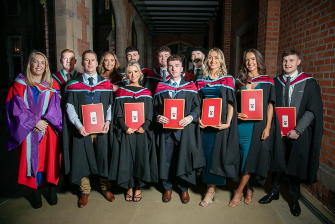 Graduates pose with their degrees at St. Mary's University College in Belfast, Northern Ireland