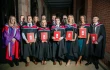 Graduates pose with their degrees at St. Mary’s University College in Belfast, Northern Ireland.