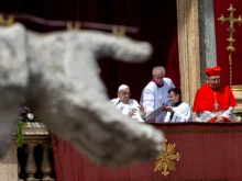 Pope Francis wishes the crowd a “happy Easter” from the central loggia of St. Peter’s Basilica on Easter Sunday, April 20, 2025.
