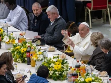 Pope Francis raises his glass at the start of a lunch with poor and economically disadvantaged people in the Vatican's Paul VI Hall on Nov. 19, 2023.