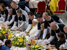 Waiters bring lunch to Pope Francis and those seated at his table on the World Day of the Poor on Nov. 19, 2023. The lunch was offered by Hilton Hotels and organized by the Vatican's charity office and the Sant'Egidio community.