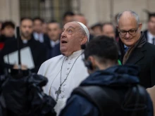 Pope Francis gazes up at the bronze statue of Mary atop the 39.4-foot column at Rome’s Spanish Steps, Dec. 8, 2024.