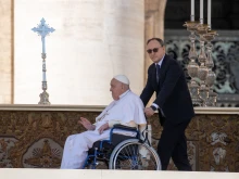 Pope Francis blesses the faithful at the Jubilee of the Sick in St. Peter's Square, Vatican City, on April 6, 2025, as his personal nurse, Massimo Strappetti, assists him in the wheelchair.