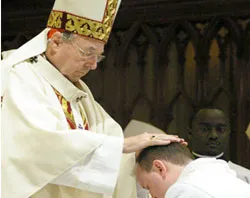 Cardinal George Pell ordains a man to the priesthood.?w=200&h=150