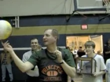 Bishop John Barres spins a basketball for admiring Catholic School students.