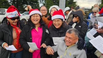 Carolers outside Planned Parenthood in Aurora, Illinois, on Dec. 13, 2025.