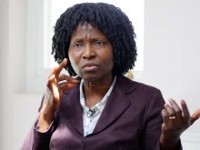 Nurse Mary Onuoha holds the cross on her necklace.