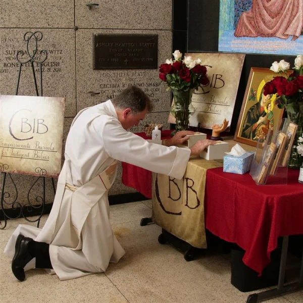 Deacon Ricky Suprean at the burial of two babies at the crypt at St. Patrick’s Cemetery in New Orleans. Credit: Photo courtesy of Compassionate Burials for Indigent Babies