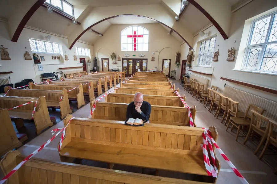 A priest prays at St. Patrick’s Catholic Church, Hendon, London, on June 14, 2020, as the church prepares to reopen following lockdown. ?w=200&h=150