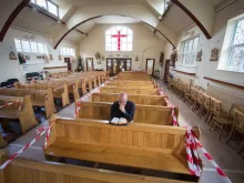 A priest prays at St. Patrick’s Catholic Church, Hendon, London, on June 14, 2020, as the church prepares to reopen following lockdown. 