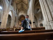 Pews at St George's Cathedral, Southwark, are cleansed after it reopened for private prayer. 