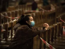 A woman prays in Westminster Cathedral, London, Nov. 4, 2020, the day before a four-week lockdown in England. 