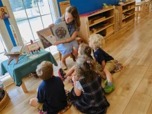 Teacher Rose Dussault reads aloud to pre-K students at St. Benedict Classical Academy in Natick, Massachusetts.