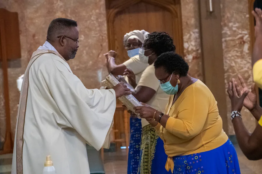 Members of the African American, African & Caribbean Apostolate hand the Evangelion to Deacon Rick Fortune at an Enduring Love service June 19 2020. ?w=200&h=150