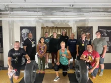Coach Joe Enabnit (far left) with members from the St. Michael Barbell Club in Cedar Rapids, Iowa.