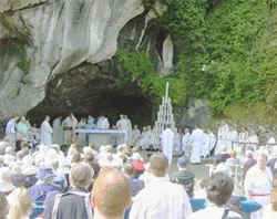 Pilgrims pray at the Marian grotto in Lourdes, France.?w=200&h=150
