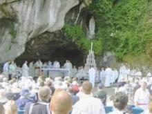 Pilgrims pray at the Marian grotto in Lourdes, France.