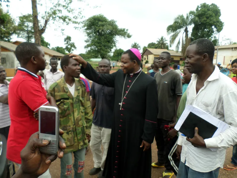 Archbishop Dieudonné Nzapalainga of Bangui blesses an ex-Seleka figher at Camp Beal. ?w=200&h=150