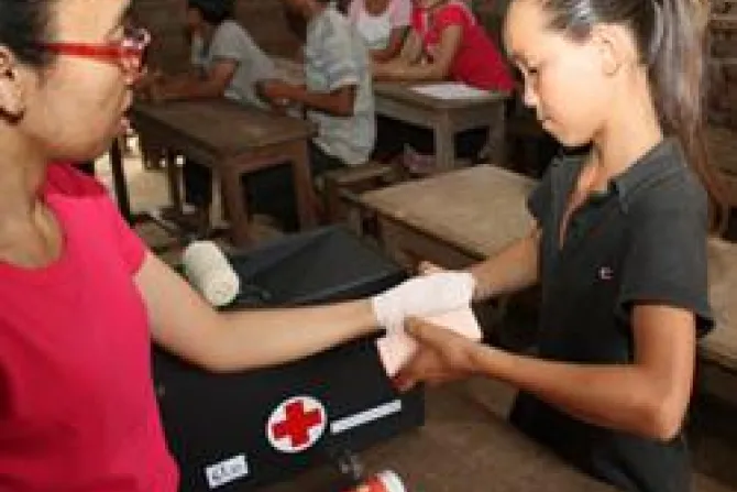 A 12 year old girl practices bandaging a hand during a first aid training clinic in Laos Credit Laura Sheahen Catholic Relief Services CNA World Catholic News 7 25 11