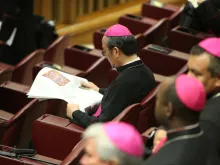 A Bishop reads a newspaper in the Vatican's Synod Hall before the Friday session of the Synod on the Family Oct. 10, 2014. 