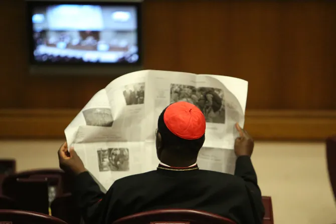 A Cardinal reads a newspaper in the Vaticans Synod Hall before the Friday session of the Synod on the Family Oct 10 2014 Credit Daniel Ib  ez CNA CNA 10 10 14