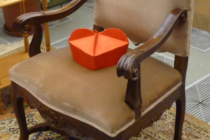 A cardinal's biretta rests on an empty chair. ?w=200&h=150