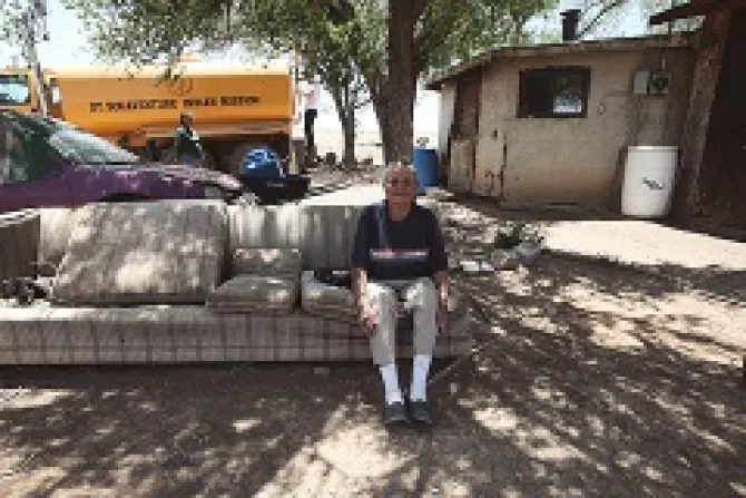 A Navejo elder sits in her yard while water is delivered to her home in Smith Lake NM Credit DigDeepWaterorg CNA 12 4 13