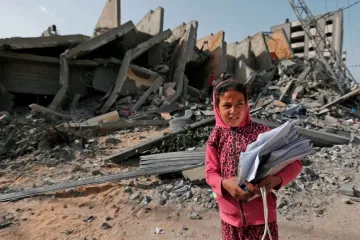 A Palestinian girl stands in front of a building destroyed during Israeli airstrikes in Gaza City May 6 2019 Credit Mahmud Hams  AFP  Getty Images 