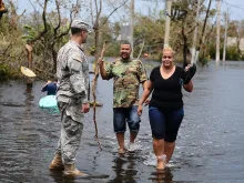 A Puerto Rico National Guard Soldier helps a couple after Hurricane Maria. Photo by Sgt. Jose Ahiram Diaz-Ramos PRNG-PAO.