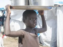 A child carrying water at the Tomping civilian protection site in Juba, South Sudan, May 6, 2014. 