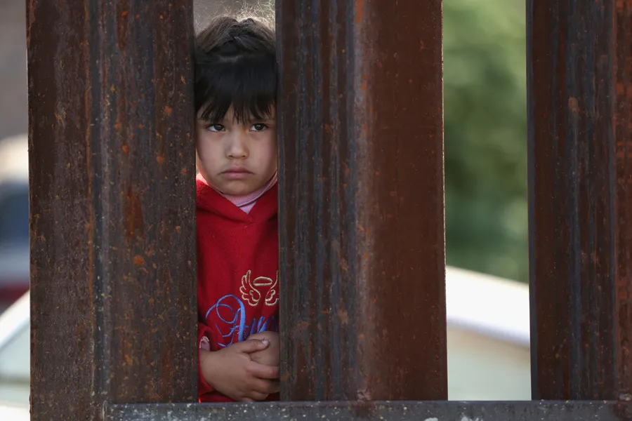 A child on the Mexican side of the U.S.-Mexico border watches the 'Mass on the Border' in Nogales, Arizona, April 1, 2014. ?w=200&h=150